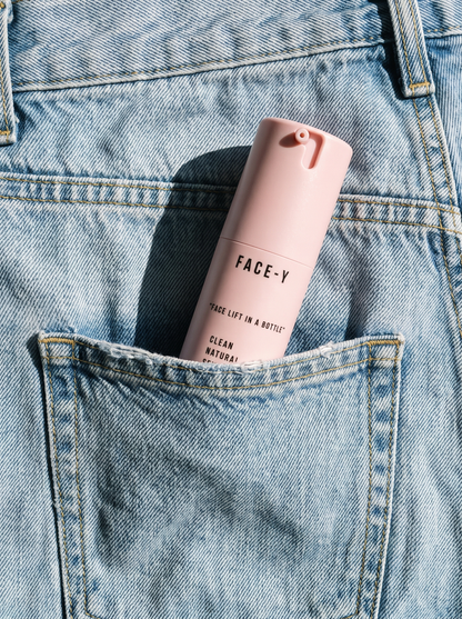 Face-y serum bottle in a jeans back pocket