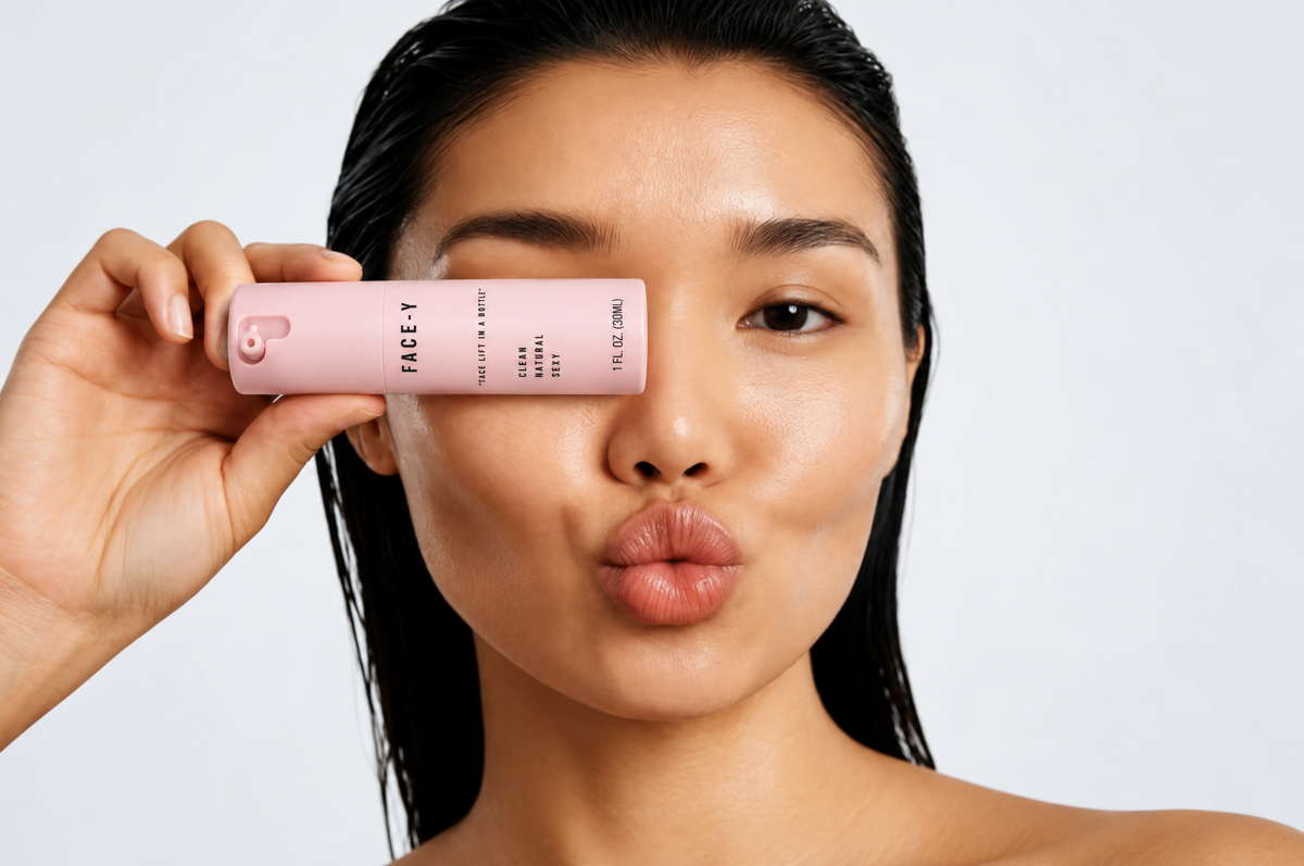 Woman holding the Face-y serum bottle over one eye